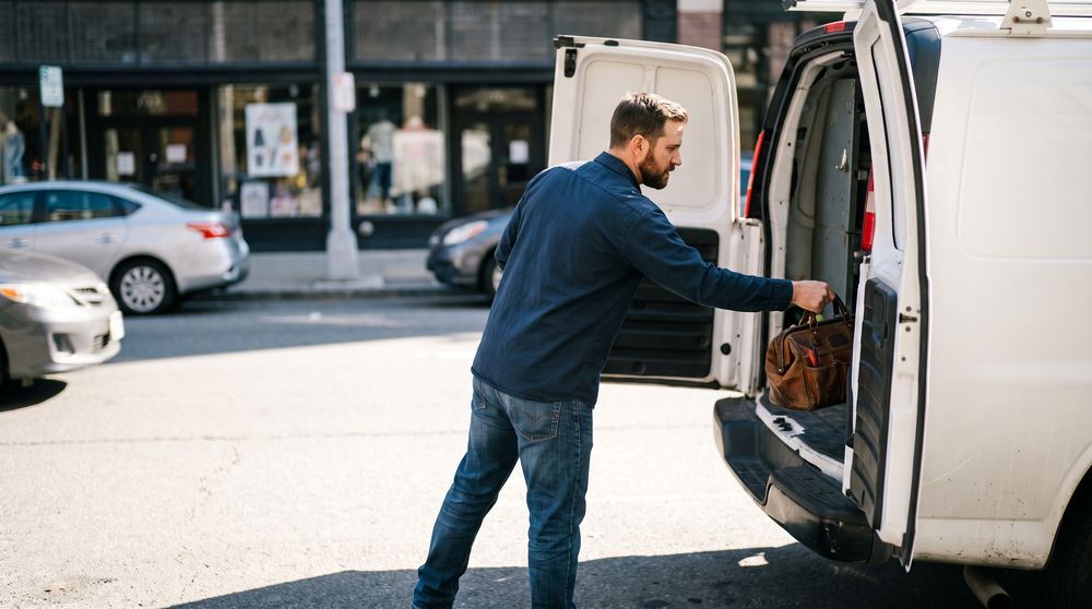 dallas contractor loading a work van on a city street